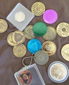 Alcoholics Anonymous tokens, given for sobriety milestones.  
Some years feel more vulnerable than others. 