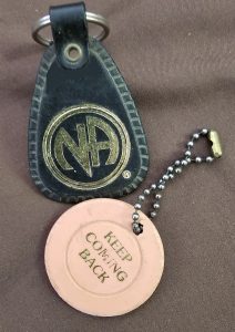 Narcotics Anonymous tokens provided for various milestones.  These tokens are for the first timer. "Keep coming back" Early recovery is a very vulnerable time. 